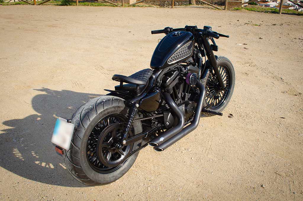 Sportster Bobber Black in a rear perspective view from left to right